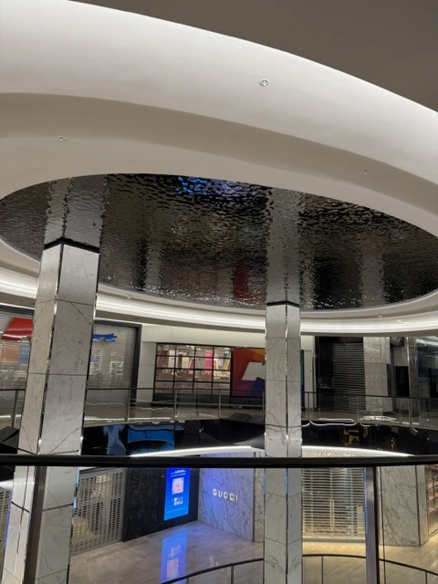 Water ripple stainless steel panels installed in a circular ceiling feature at Westfield Bondi, NSW