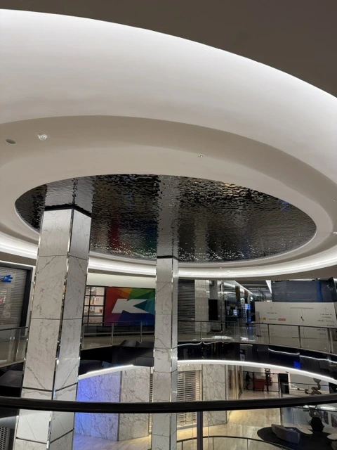 Water ripple stainless steel panels reflecting the multi-level interior of Westfield Bondi Shopping Centre